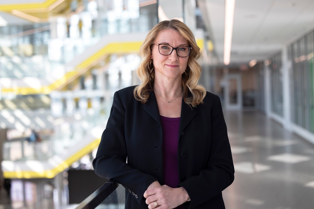 Jennifer Judge Hensel, wearing black glasses and a black blazer